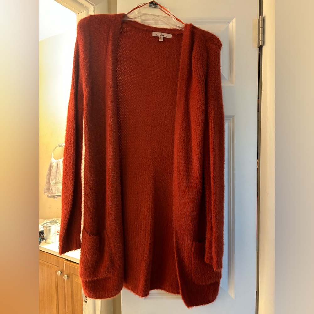 Fuzzy cardigan size small. Looks worn in photo but that’s just the material